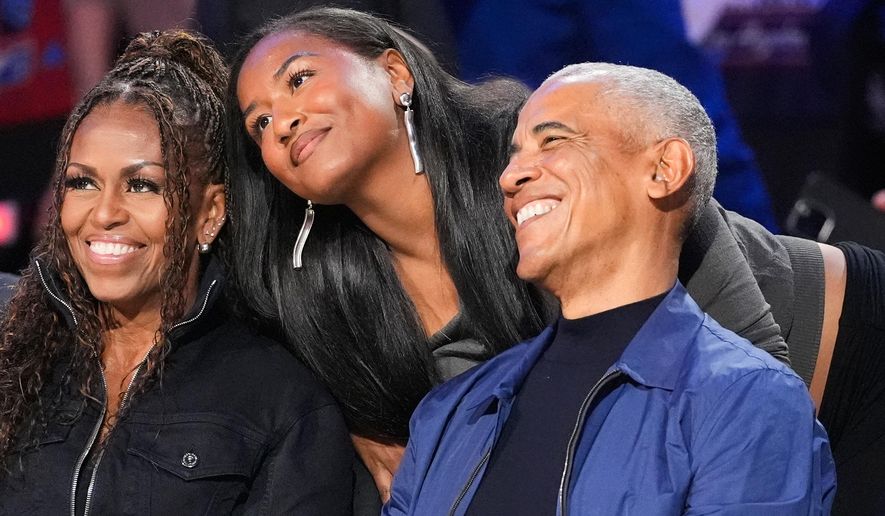 From left, Michelle Obama, Sasha Obama and Barack Obama pose for a photo before the NBA All-Star basketball game Sunday, Feb. 15, 2026, in Inglewood, Calif. (AP Photo/Mark J. Terrill)