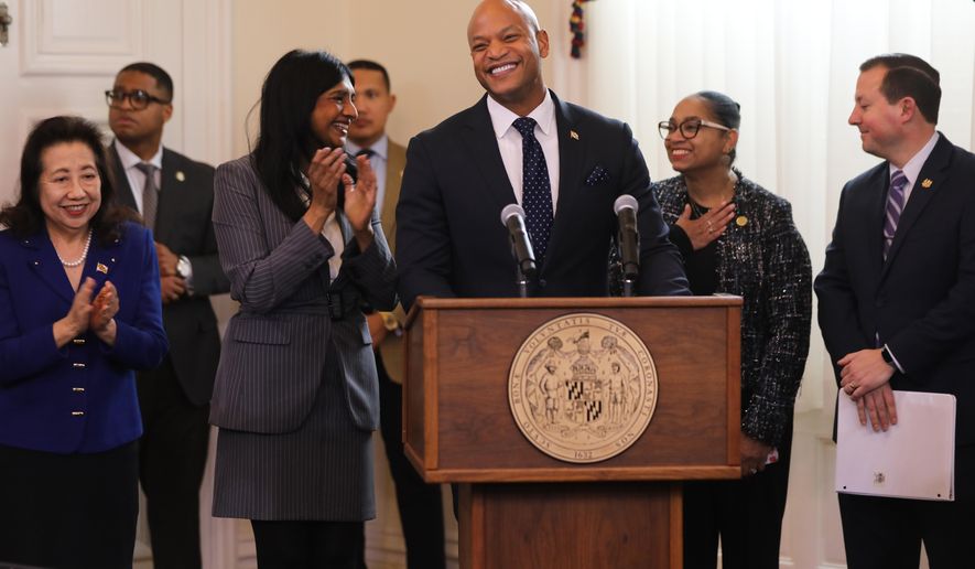 Maryland Gov. Wes Moore, center, smiles before signing legislation that prohibits immigration enforcement agreements with the federal government during a bill-signing ceremony Tuesday, Feb. 17, 2026, in Annapolis, Md. He is joined, from left, by Maryland Secretary of State Susan Lee, Lt. Gov. Aruna Miller, House Speaker Peña-Melnyk and Senate President Bill Ferguson. (AP Photo/Brian Witte)