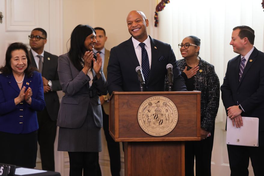 Maryland Gov. Wes Moore, center, smiles before signing legislation that prohibits immigration enforcement agreements with the federal government during a bill-signing ceremony Tuesday, Feb. 17, 2026, in Annapolis, Md. He is joined, from left, by Maryland Secretary of State Susan Lee, Lt. Gov. Aruna Miller, House Speaker Peña-Melnyk and Senate President Bill Ferguson. (AP Photo/Brian Witte)