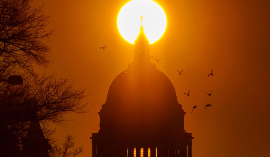 FILE - Birds fly near the U.S. Capitol during sunrise, Feb. 13, 2026, in Washington. (AP Photo/Tom Brenner, File)
