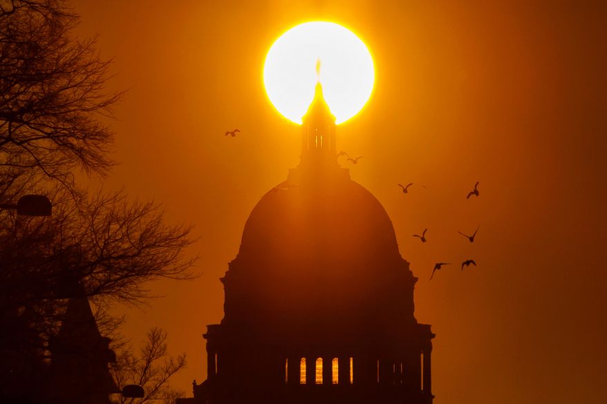 FILE - Birds fly near the U.S. Capitol during sunrise, Feb. 13, 2026, in Washington. (AP Photo/Tom Brenner, File)
