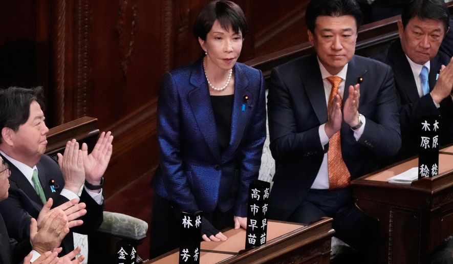 Japanese Prime Minister Sanae Takaichi, center, is applauded by members of the lower house of Japan's parliament as Takaichi was reelected as prime minister during a special session in Tokyo, Japan, Wednesday, Feb. 18, 2026. (AP Photo/Eugene Hoshiko)
