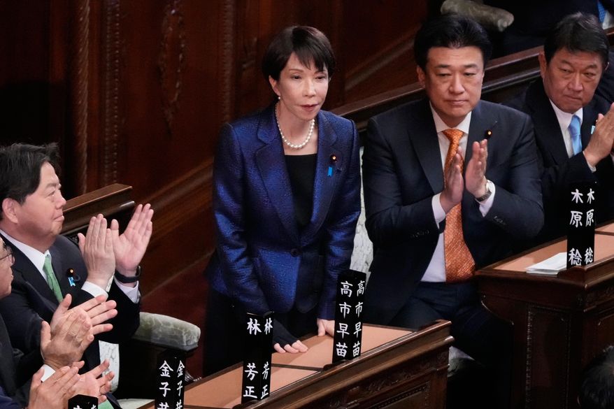 Japanese Prime Minister Sanae Takaichi, center, is applauded by members of the lower house of Japan's parliament as Takaichi was reelected as prime minister during a special session in Tokyo, Japan, Wednesday, Feb. 18, 2026. (AP Photo/Eugene Hoshiko)