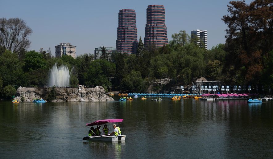 People ride on a row boat in Chapultepec Park in Mexico City, Tuesday, Feb. 17, 2026. (AP Photo/Marco Ugarte)