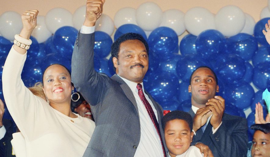 FILE - Jesse Jackson is joined by his daughter, Santita, and son Jonathan, far right, and unidentified youngster at the Los Angeles Hilton Hotel, June 8, 1988 after falling in defeat to Massachusetts Gov. Michael Dukakis in the California Democratic primary. (AP Photo/John Duricka, File)