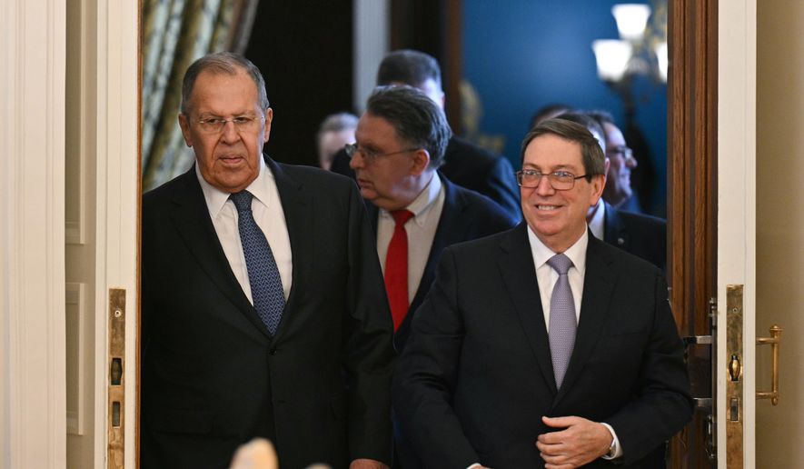 Russian Foreign Minister Sergey Lavrov, left, and Cuban Foreign Minister Bruno Rodriguez enter a hall during their meeting in Moscow, Russia, Wednesday, Feb. 18, 2026. (Hector Retamal/Pool Photo via AP)