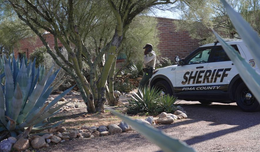 A Pima County sheriffs official stays outside of Nancy Guthrie‘s home on Saturday, Feb. 14, 2026 in Tucson, Ariz. (AP Photo/Ty O'Neil)