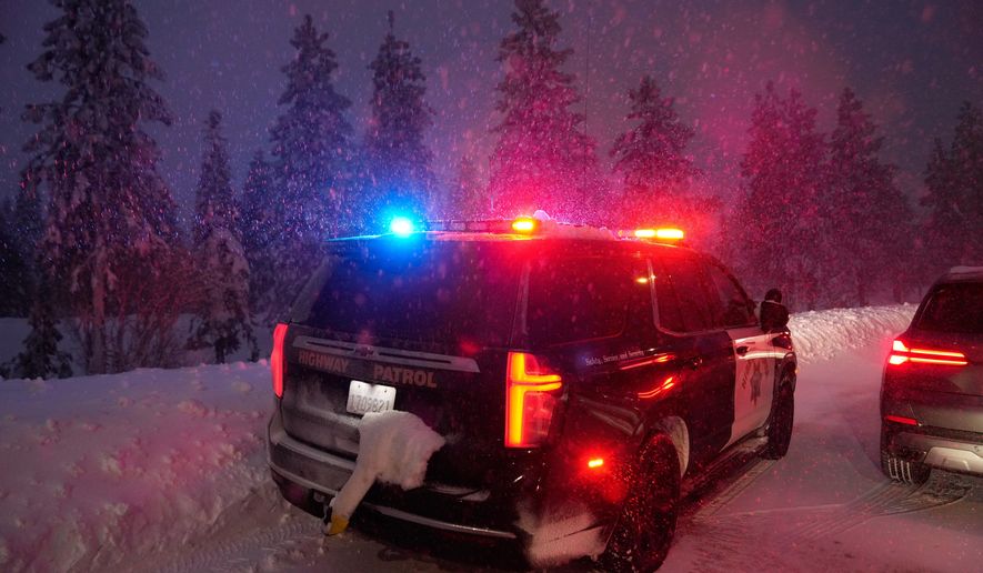 A California Highway Patrol vehicle is parked along a road during a snow storm Wednesday, Feb. 18, 2026, in Placer County, Calf. (AP Photo/Godofredo A. Vásquez)