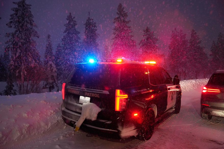 A California Highway Patrol vehicle is parked along a road during a snow storm Wednesday, Feb. 18, 2026, in Placer County, Calf. (AP Photo/Godofredo A. Vásquez)