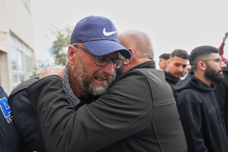 Mourners give condolences to Mohammad Abu Siyam, the father of Palestinian-American Nasrallah Abu Siyam, 19, who according to the Palestinian Health Ministry was shot by settlers on Wednesday night, during his funeral in the West Bank village of Mukhmas, east of Ramallah, Thursday, Feb. 19, 2026. (AP Photo/Nasser Nasser)