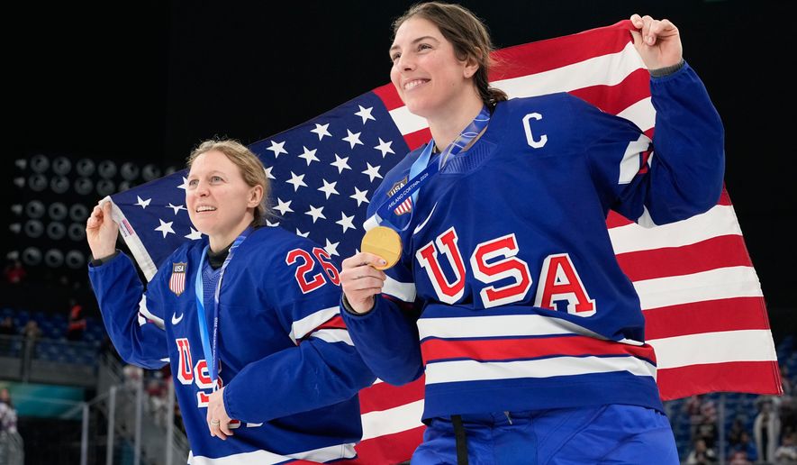 United States' Kendall Coyne, left, and United States' Hilary Knight celebrate after victory ceremony for women's ice hockey at the 2026 Winter Olympics, in Milan, Italy, Thursday, Feb. 19, 2026. (AP Photo/Hassan Ammar)