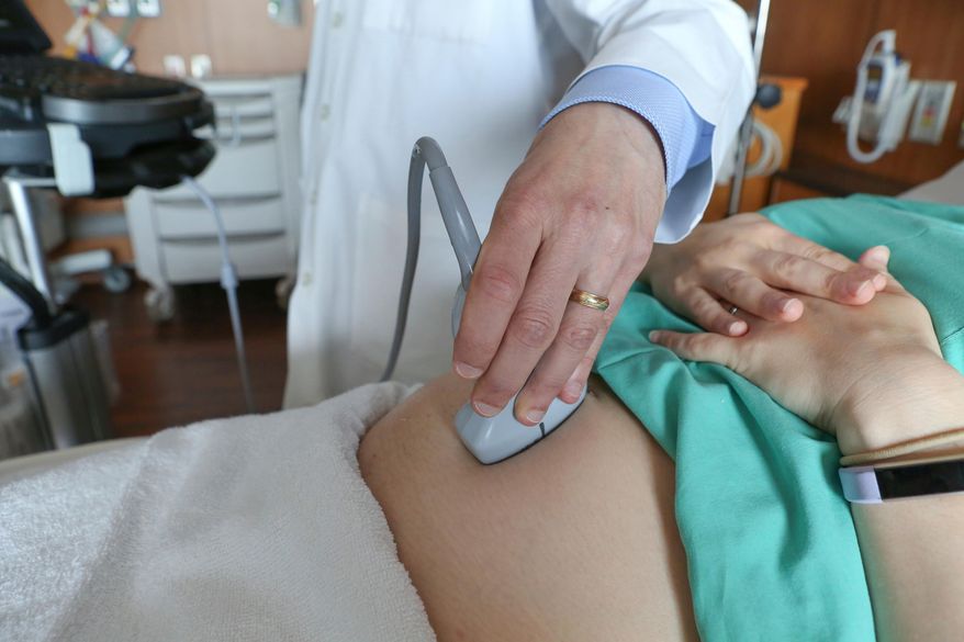 A doctor performs an ultrasound scan on a pregnant woman at a hospital in Chicago on Aug. 7, 2018. (AP Photo/Teresa Crawford, File)