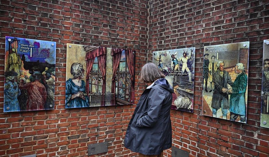 A person views panels that were part of an exhibit on slavery at the President's House Site in Philadelphia after they are put back Thursday, Feb. 19, 2026. (AP Photo/Joe Lamberti)