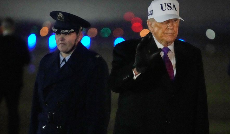 President Donald Trump waves after stepping off Air Force One, Thursday, Feb. 19, 2026, at Joint Base Andrews, Md., on return from a trip to Georgia. (AP Photo/Mark Schiefelbein)