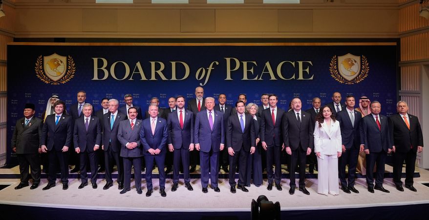 President Donald Trump stands with other World leaders before a Board of Peace meeting at the U.S. Institute of Peace, Thursday, Feb. 19, 2026, in Washington. (AP Photo/Mark Schiefelbein)