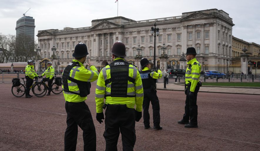 Police officers stand in front of Buckingham Palace in London, Friday, Feb. 20, 2026. (AP Photo/Kin Cheung) ** FILE **