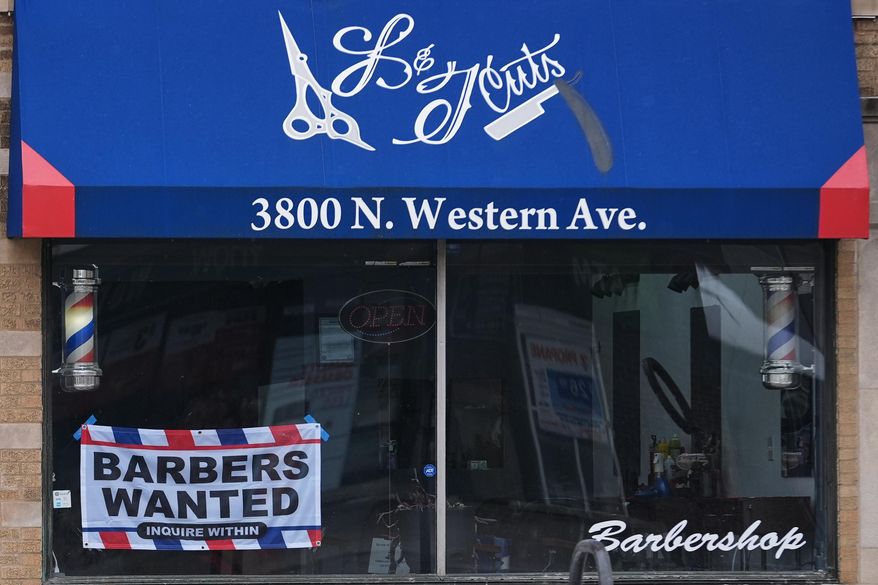 Hiring sign is displayed at a barbershop in Chicago, Thursday, Feb. 5, 2026. (AP Photo/Nam Y. Huh)