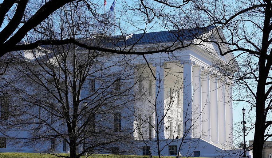 The state and U.S. flags fly over the Virginia State Capitol at the start of the 2024 session of the Virginia General Assembly in Richmond, Va., on Jan. 10, 2024. (AP Photo/Steve Helber, File)