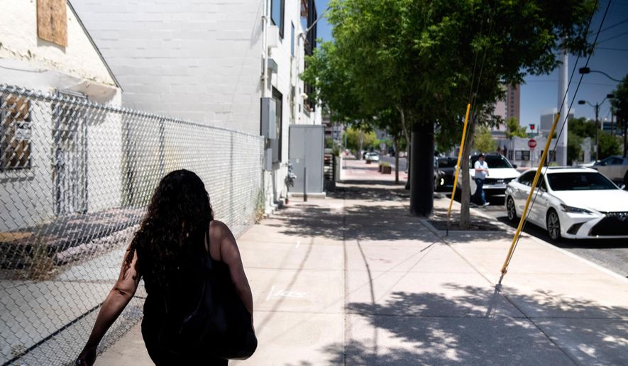 A woman adopted as a toddler by an American war veteran, who he found in the 1970s in an Iranian orphanage and raised as a Christian, walks down a Las Vegas street Wednesday, June 26, 2024. (AP Photo/David Goldman, File)