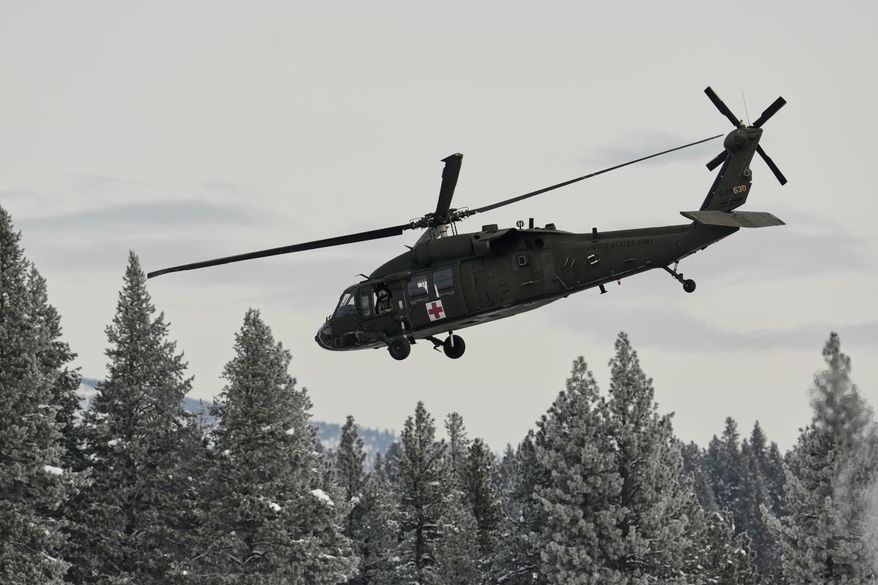 A U.S. Army Blackhawk helicopter takes off from the Truckee Tahoe Airport as recovery efforts for a group of missing skiers continue, continue in Truckee, Calif., Saturday, Feb. 21, 2026. (AP Photo/Godofredo A. Vásquez)