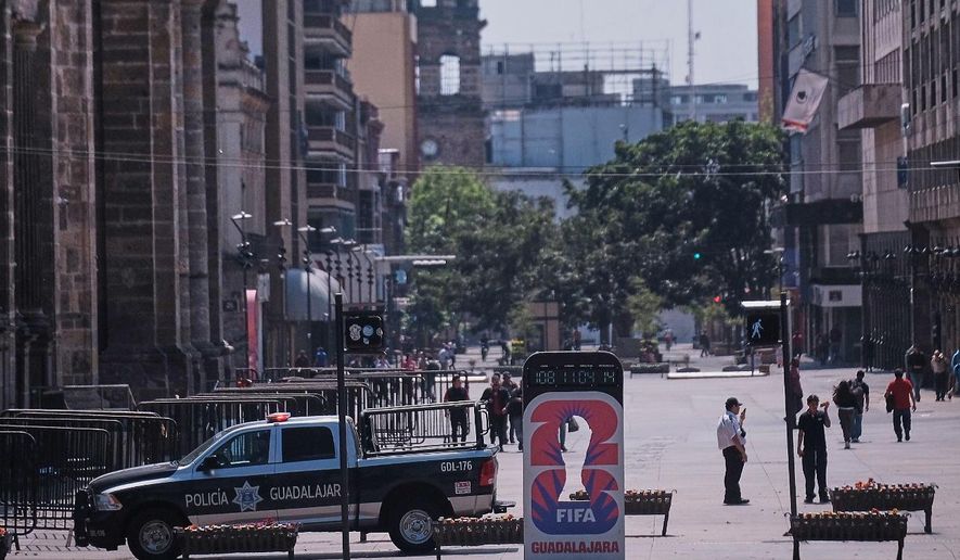 Police officers stand guard in downtown Guadalajara, Jalisco state, Mexico, Sunday, Feb. 22, 2026, after the death of the leader of the Jalisco New Generation Cartel, Nemesio Rubén Oseguera Cervantes, known as "El Mencho." (AP Photo/Alejandra Leyva)