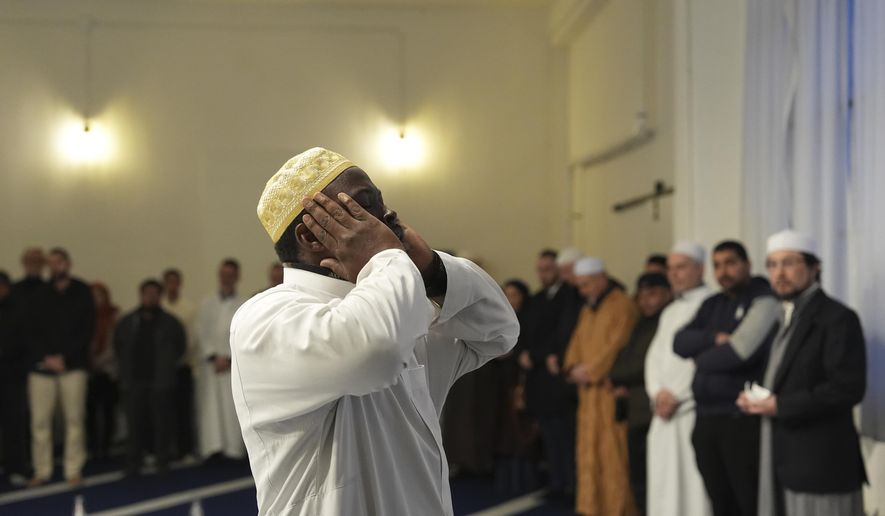 Imam Abd al-Basit calls to prayer at the Al-Wahid mosque during Ramadan in Milan, Italy, Friday, Feb. 20, 2026, as the city hosts the Winter Olympics. (AP Photo/María Teresa Hernández)