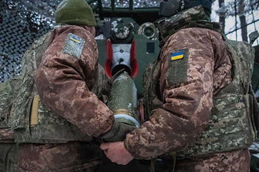 Ukrainian servicemen load an artillery shell before firing at Russian positions on the front line in Kharkiv region of Ukraine, Wednesday, Feb. 18, 2026. (AP Photo/Andrii Marienko, File)