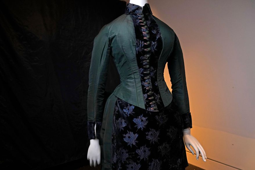 A vintage walking dress is held in preparation for The Metropolitan Museum of Art's spring exhibition, "Costume Art," on Thursday, Feb. 12, 2026, in New York. (Photo by Charles Sykes/Invision/AP)