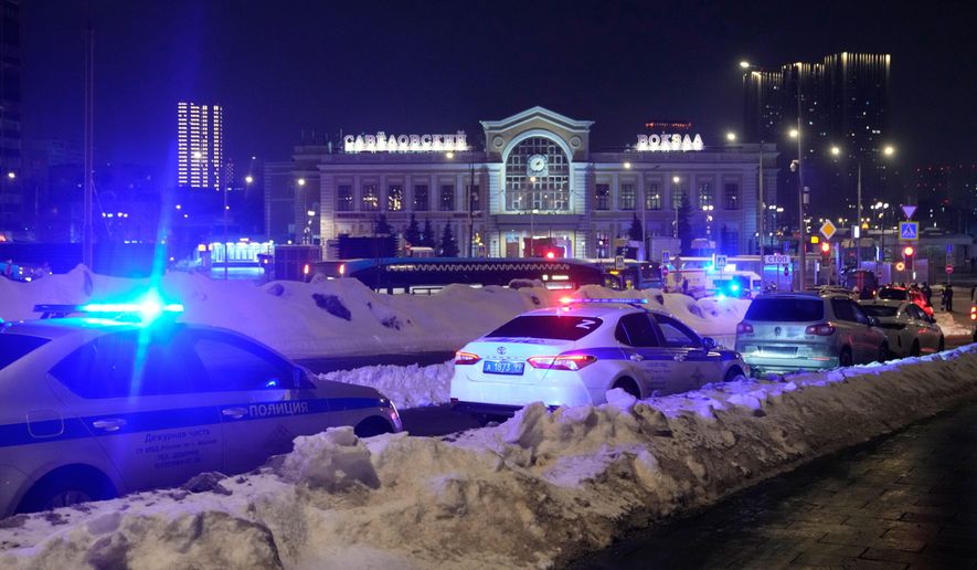 Police and emergency services are seen at the scene of an attack on a police patrol near the Savyolovsky Railway Station, in Moscow, Tuesday, Feb. 24, 2026. (AP Photo)
