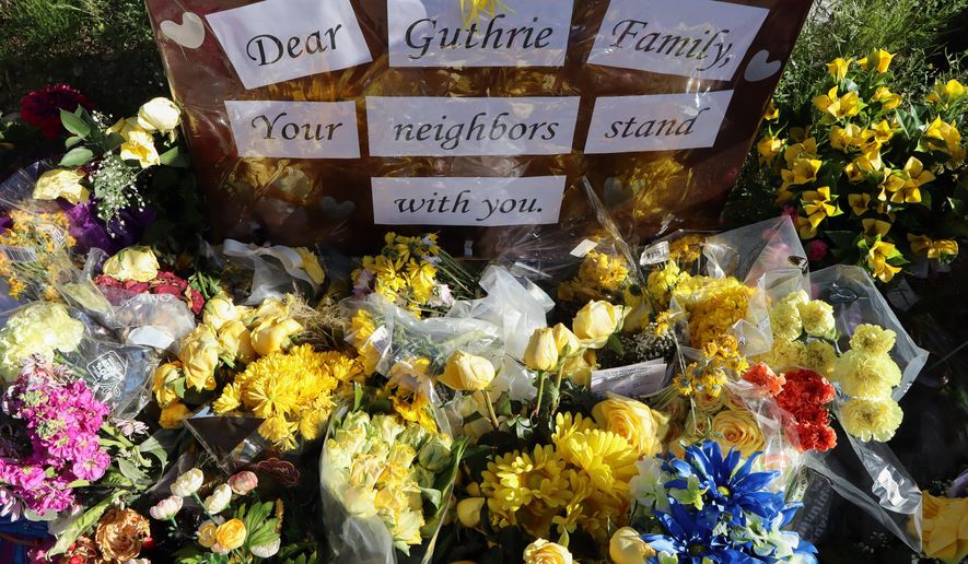 A memorial grows outside the home of Nancy Guthrie, the missing mother of "Today" show host Savannah Guthrie, Sunday, Feb. 22, 2026, in Tucson, Ariz. (AP Photo/Felicia Fonseca)