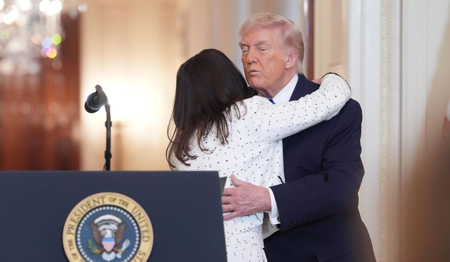 Allyson Phillips, the mother of Laken Riley, is hugged by President Donald Trump, during an event to proclaim "Angel Family Day" in the East Room of the White House, Monday, Feb. 23, 2026, in Washington. (AP Photo/Evan Vucci)