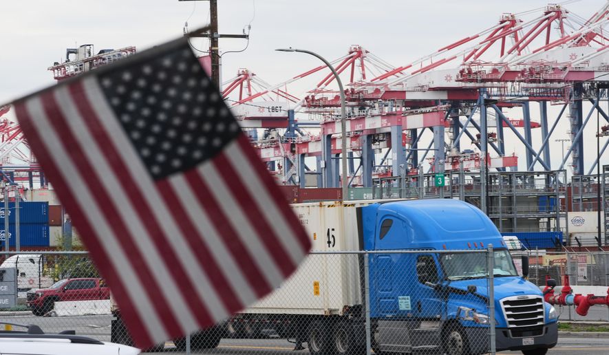 A U.S. flag files at the Port of Long Beach Friday, Feb. 20, 2026, in Long Beach, Calif. (AP Photo/Damian Dovarganes)