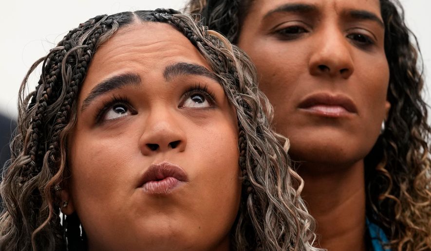 Luyara Franco, daughter of late councilwoman Marielle Franco, and her aunt Anielle Franco give a press conference at the Supreme Court before the start of the first day of trial of those accused of ordering Marielle's murder, in Brasilia, Brazil, Tuesday, Feb. 24, 2026. (AP Photo/Eraldo Peres)