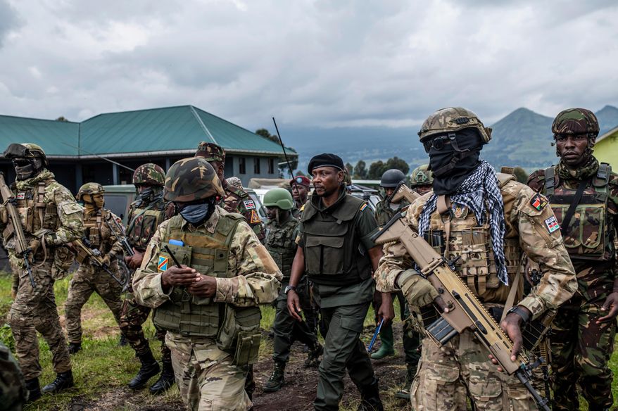FILE - Surrounded by members of the Kenya Defence Forces (KDF), Willy Ngoma, spokesman of the M23, center, arrives for a ceremony to mark the withdrawal from their positions in the town of Kibumba, in the eastern of Democratic Republic of Congo, Friday, Dec. 23, 2022. (AP Photo/Moses Sawasawa, File)
