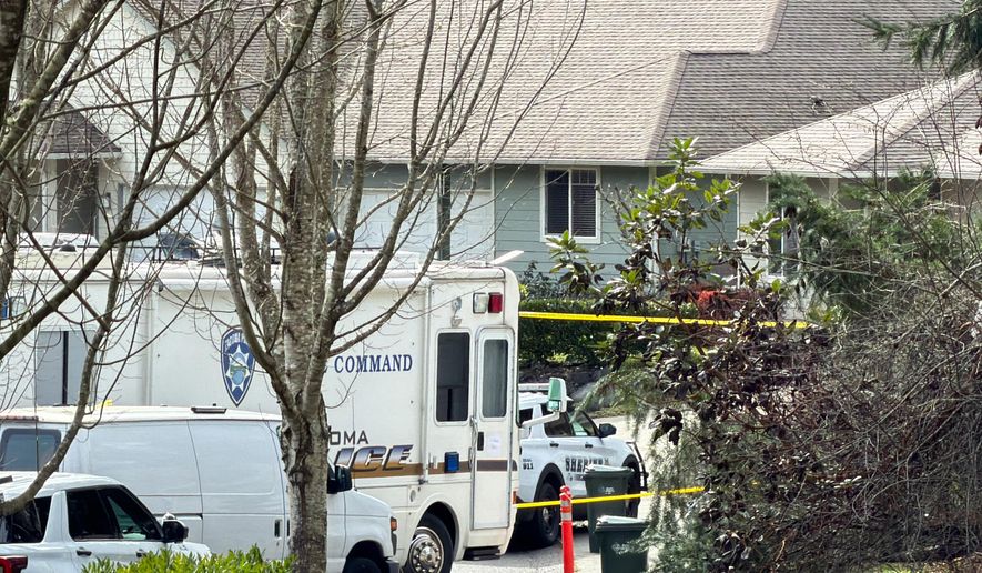 Authorities investigate the scene after reports that a person fatally stabbed multiple people on Tuesday, Feb. 24, 2026, in Gig Harbor, Wash. (AP Photo/John Froschauer)