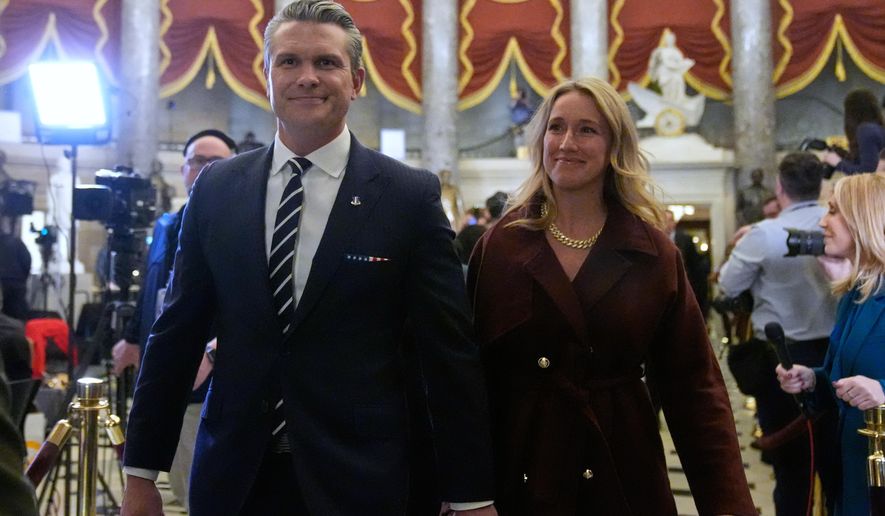 Defense Secretary Pete Hegseth and his wife Jennifer Rauchet arrive before President Donald Trump delivers the State of the Union address to a joint session of Congress in the House chamber at the U.S. Capitol in Washington, Tuesday, Feb. 24, 2026. (AP Photo/Mark Schiefelbein)