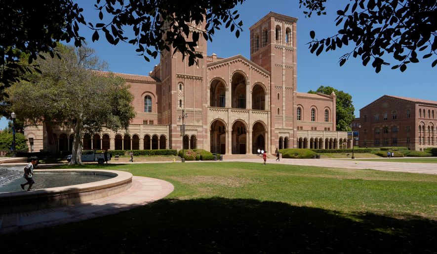 FILE - Children play outside Royce Hall at the University of California, Los Angeles, campus, Aug. 15, 2024. (AP Photo/Damian Dovarganes, File)