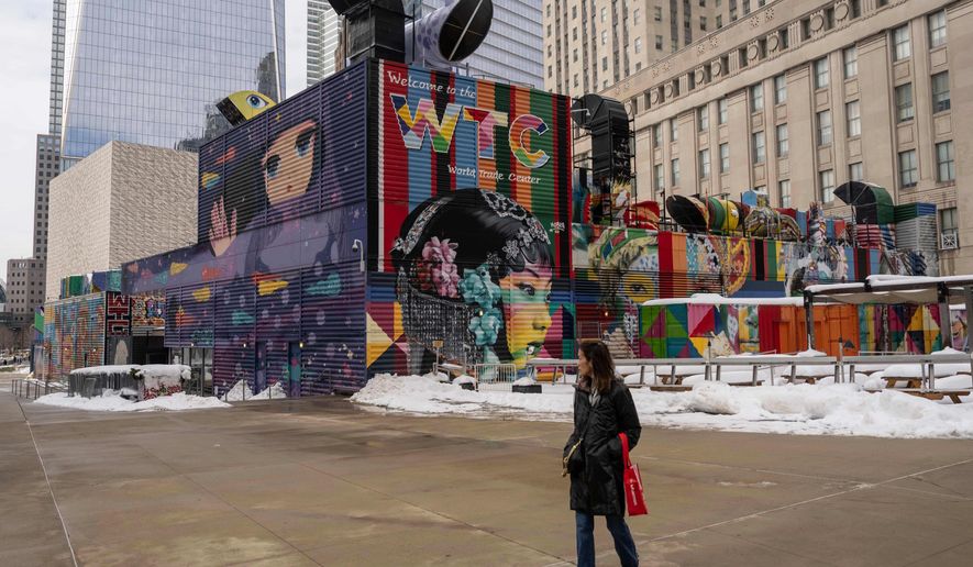A person walks past 2 World Trade Center where American Express will build new global headquarters, Wednesday, Feb. 25, 2026, in New York. (AP Photo/Yuki Iwamura)