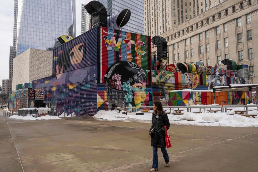 A person walks past 2 World Trade Center where American Express will build new global headquarters, Wednesday, Feb. 25, 2026, in New York. (AP Photo/Yuki Iwamura)