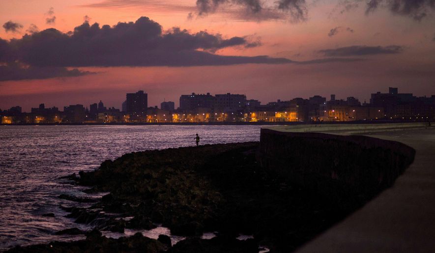 A fisherman casts his line along the Malecon at sunrise in Havana, Cuba, Wednesday, Oct. 8, 2014. (AP Photo/Ramon Espinosa, File)