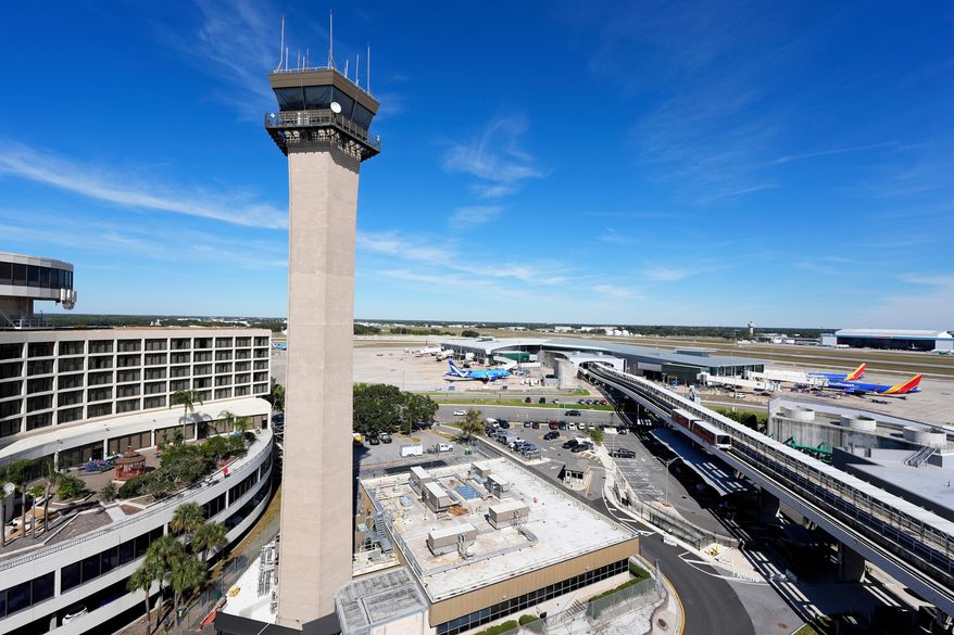 Airplanes are parked at gates near the air traffic control tower at the Tampa International Airport, Nov. 11, 2025, in Tampa, Fla. (AP Photo/Chris O'Meara) **FILE**