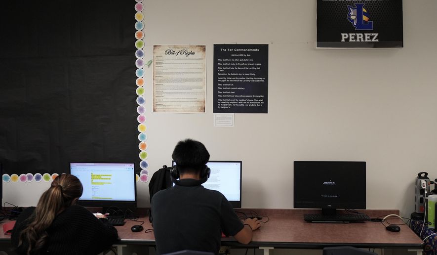 Students work under Ten Commandments and Bill of Rights posters on display in a classroom at Lehman High School, in Kyle, Texas, Oct. 16, 2025. (AP Photo/Eric Gay, File)
