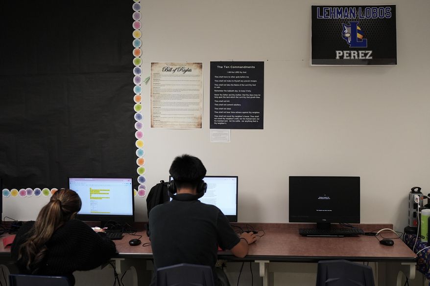 Students work under Ten Commandments and Bill of Rights posters on display in a classroom at Lehman High School, in Kyle, Texas, Oct. 16, 2025. (AP Photo/Eric Gay, File)