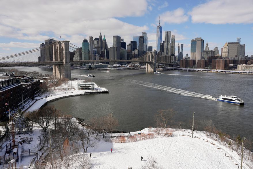 Ferries pass Brooklyn Bridge Park along the East River, Tuesday, Feb. 24, 2026, in New York. (AP Photo/Yuki Iwamura)