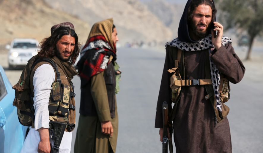 Afghan Taliban soldiers stand on the Afghan side of the Torkham border crossing with Pakistan in Torkham, Afghanistan, Friday, Feb. 27, 2026. (AP Photo/Wahidullah Kakar)