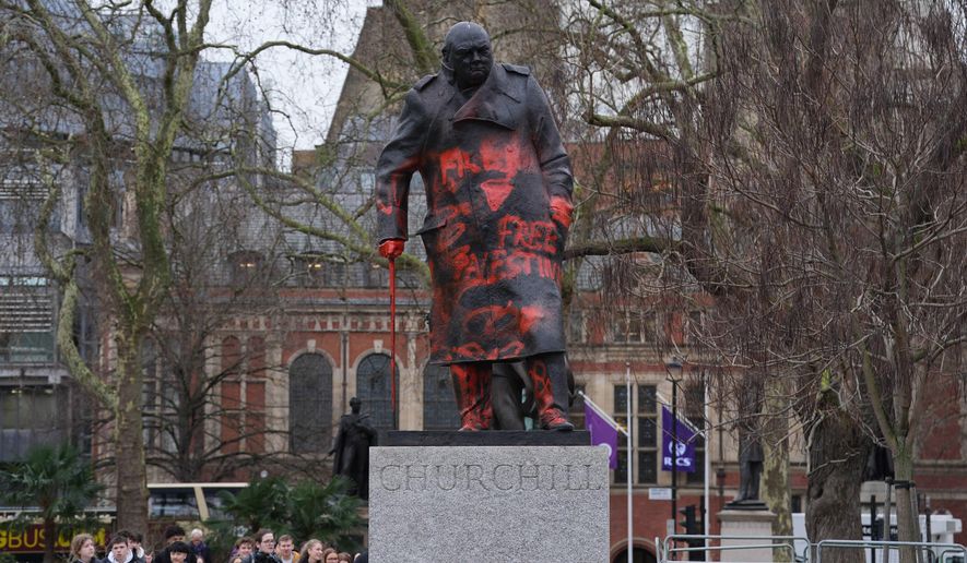 A view of the statue of Winston Churchill in Parliament Square, defaced with graffiti, in London, Friday, Feb. 27, 2026. (Lucy North/PA via AP)