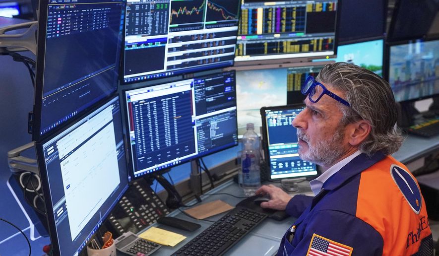 Trader John Romolo works on the floor of the New York Stock Exchange, Friday, Feb. 20, 2026. (AP Photo/Richard Drew)