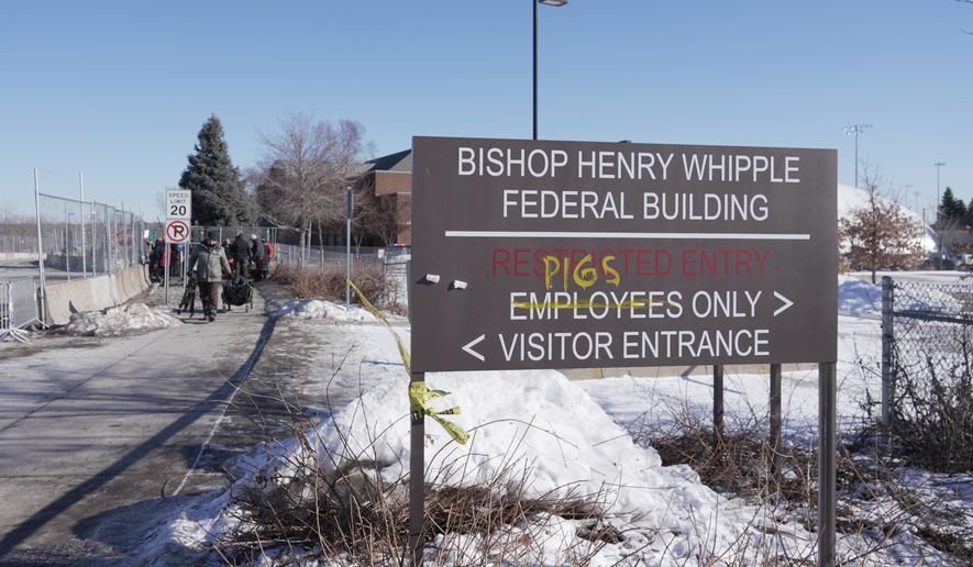 Protesters yell at cars coming and going near a defaced sign for Bishop Whipple Federal building in Minneapolis on Wednesday, Jan. 28, 2026. (AP Photo/Laura Bargfeld) **FILE**