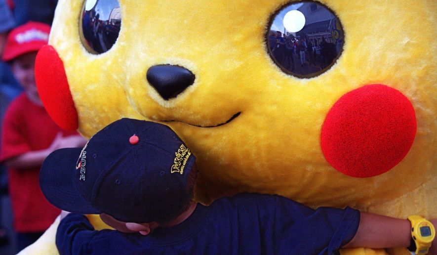 FILE - Daniel Osugi, 7, of Long Beach, Calif., hugs an oversized Pokemon character known as "Pikachu" at the premiere of the new Warner Bros. animated feature, "Pokemon The First Movie," Nov. 6, 1999, at the Mann's Chinese Theatre, in Los Angeles. (AP Photo/Chris Pizzello, File)