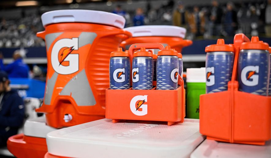 Gatorade bottles and coolers are seen on the sideline before an NFL football game between the Dallas Cowboys and the Minnesota Vikings, Dec. 14, 2025, in Arlington, Texas. (AP Photo/Jerome Miron, file)